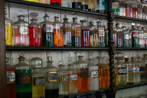 Shelves of laboratory reagent bottles in a storage room