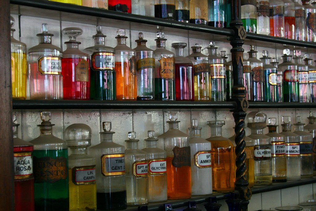 Shelves of laboratory reagent bottles in a storage room